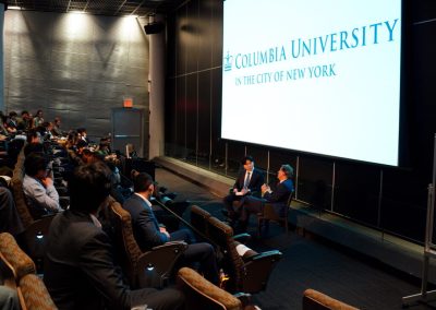 Side view of the Columbia University audience at the Weston Talks event with Blair Effron and Siyang Ding seated by the screen